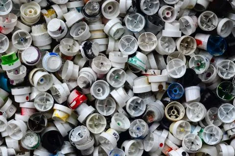 A pattern of many used and soiled nozzles from spray cans with aerosol paint. Stock Photos