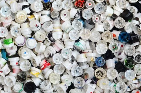 A pattern of many used and soiled nozzles from spray cans with aerosol paint. Stock Photos