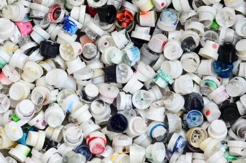 A pattern of many used and soiled nozzles from spray cans with aerosol paint. Stock Photos