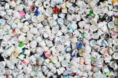 A pattern of many used and soiled nozzles from spray cans with aerosol paint. Stock Photos
