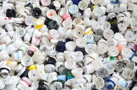 A pattern of many used and soiled nozzles from spray cans with aerosol paint. Stock Photos