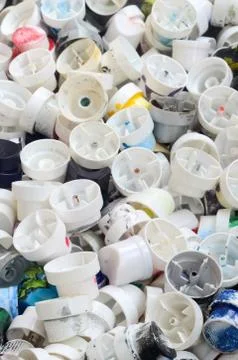 A pattern of many used and soiled nozzles from spray cans with aerosol paint. Stock Photos