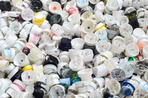 A pattern of many used and soiled nozzles from spray cans with aerosol paint. Stock Photos