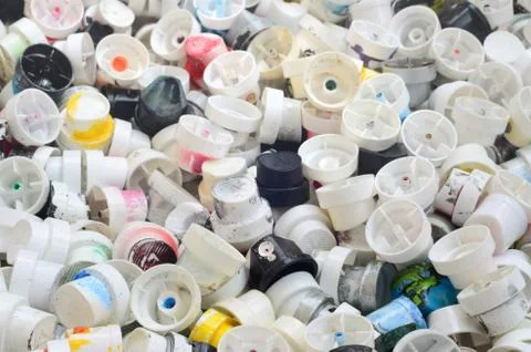 A pattern of many used and soiled nozzles from spray cans with aerosol paint. Stock Photos