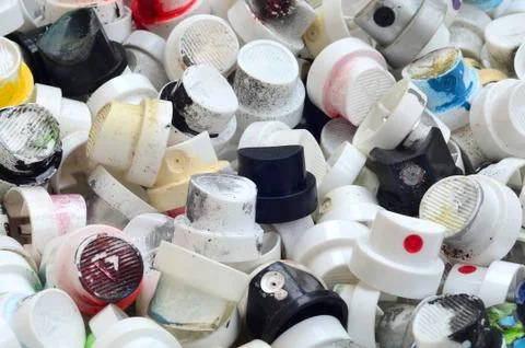 A pattern of many used and soiled nozzles from spray cans with aerosol paint. Stock Photos