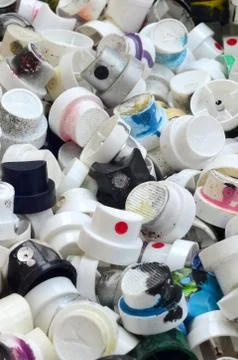 A pattern of many used and soiled nozzles from spray cans with aerosol paint. Stock Photos