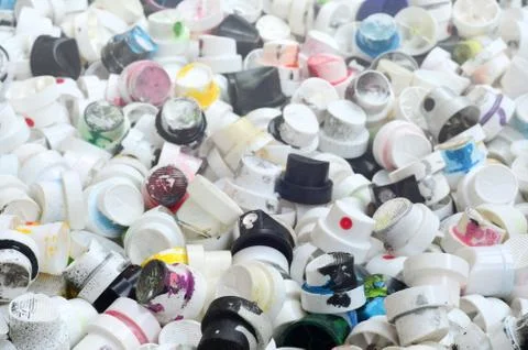 A pattern of many used and soiled nozzles from spray cans with aerosol paint. Stock Photos