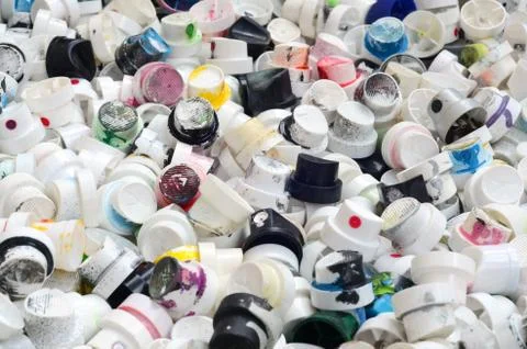 A pattern of many used and soiled nozzles from spray cans with aerosol paint. Stock Photos