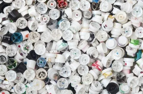 A pattern of many used and soiled nozzles from spray cans with aerosol paint. Stock Photos