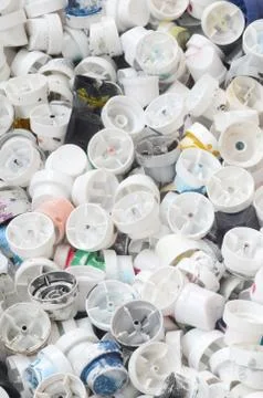 A pattern of many used and soiled nozzles from spray cans with aerosol paint. Stock Photos