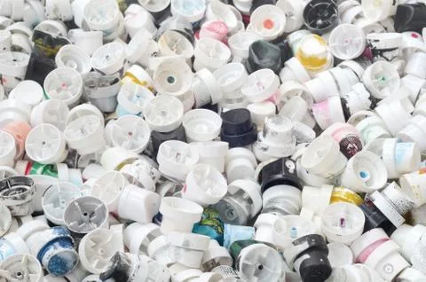 A pattern of many used and soiled nozzles from spray cans with aerosol paint. Stock Photos