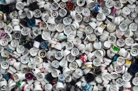 A pattern of many used and soiled nozzles from spray cans with aerosol paint. Stock Photos