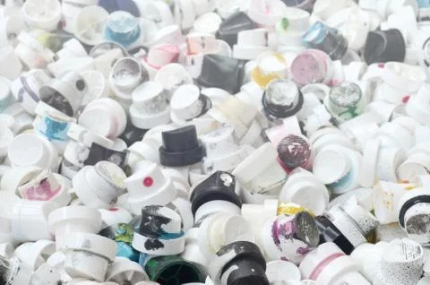 A pattern of many used and soiled nozzles from spray cans with aerosol paint. Stock Photos