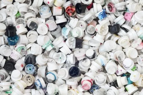 A pattern of many used and soiled nozzles from spray cans with aerosol paint. Stock Photos