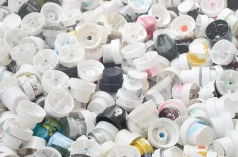 A pattern of many used and soiled nozzles from spray cans with aerosol paint. Stock Photos