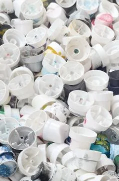 A pattern of many used and soiled nozzles from spray cans with aerosol paint. Stock Photos