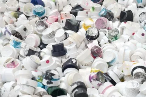 A pattern of many used and soiled nozzles from spray cans with aerosol paint. Stock Photos