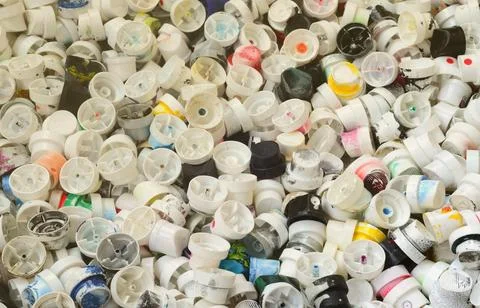 A pattern of many used and soiled nozzles from spray cans with aerosol paint Stock Photos