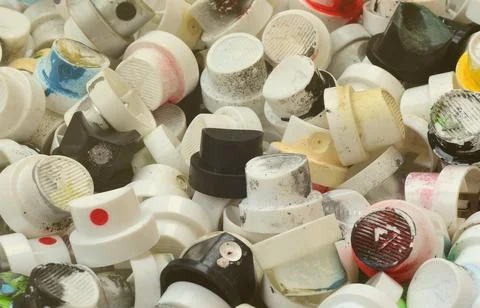 A pattern of many used and soiled nozzles from spray cans with aerosol paint Stock Photos