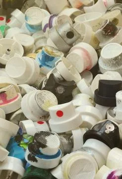 A pattern of many used and soiled nozzles from spray cans with aerosol paint Stock Photos