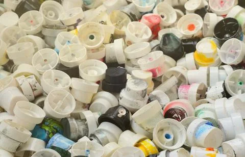 A pattern of many used and soiled nozzles from spray cans with aerosol paint Stock Photos