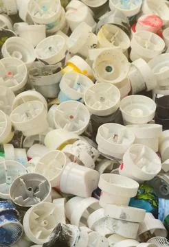 A pattern of many used and soiled nozzles from spray cans with aerosol paint Stock Photos