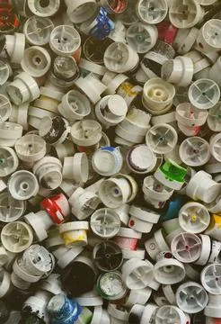 A pattern of many used and soiled nozzles from spray cans with aerosol paint Stock Photos