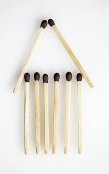 Pattern of matchsticks forming the shape of a simple house Stock Photos