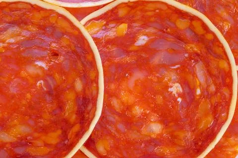 Pattern of meat and cheese textures, Repeating meat circles creating contrasting 스톡 사진