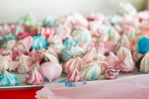 Pattern with meringues on a white background. Multicolored meringues on a whi Stock Photos