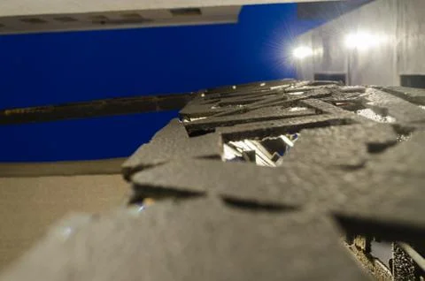 Pattern of metal structures of black color, with buildings in the background  Stock Photos