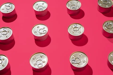 Pattern of metal tin cans on pink background Stock Photos