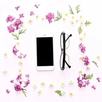 Pattern with mobile phone  glasses and lilac flowers Stock Photos