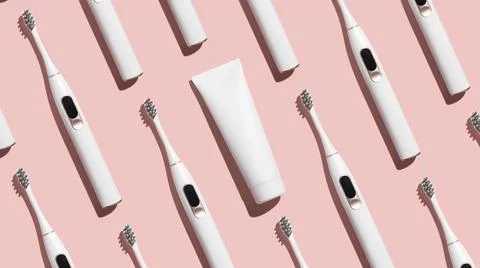 Pattern from mock up toothbrush and toothpaste on pink background Stock Photos