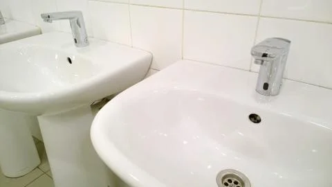 Pattern of modern bathroom sink and faucet in public toilet and restroom. Stock Photos