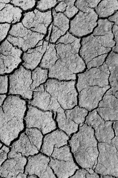 Pattern of mud cracks in dry soil as a result of drought Stock Photos