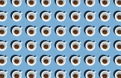 A pattern of a mug with instant coffee poured into it on a blue background. T Stock Photos