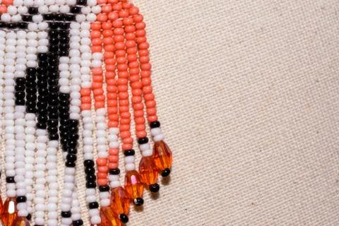 Pattern of multi-colored beads on a white fabric Stock Photos