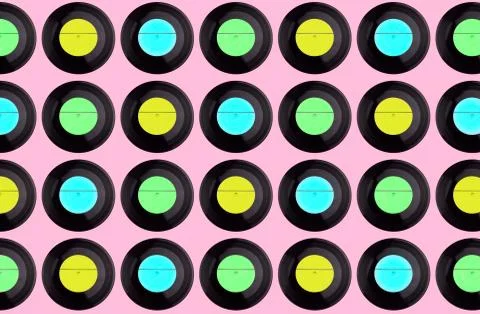 Pattern of multicolored vinyl discs on a pink background Stock Photos