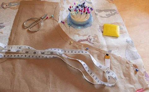 A pattern, needles and a fabric on the workshop table 写真素材