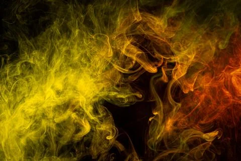Pattern, Neon yellow  and  orange smoke in the  on a dark isolated background Foto stock