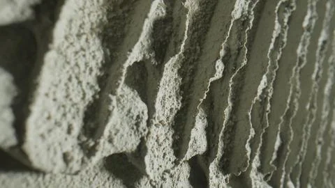 Pattern of notched trowel strokes on the gray surface of cement putty for laying Stock Photos