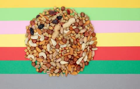 Pattern of nuts in circle form. Various nuts on colorful paper background. Stock Photos