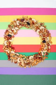 Pattern of nuts in circle form. Various nuts on colorful paper Stock Photos