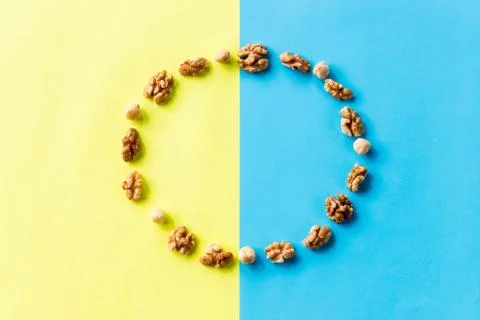 Pattern of nuts in circle form. Various nuts isolated on colorful. brazil nut Stock Photos