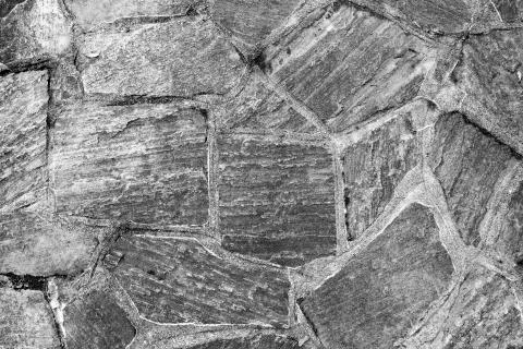 Pattern of old irregular stones gives a harmonic background Stock Photos