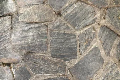 Pattern of old irregular stones gives a harmonic background Stock Photos