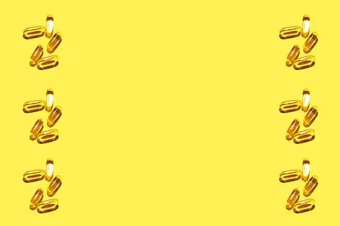 Pattern from omega vitamins with hard light on a yellow background. Yellow ov Stock Photos