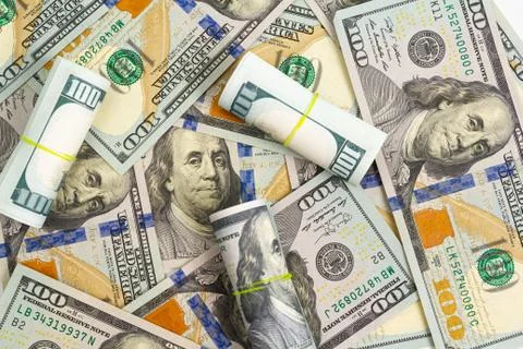 Pattern of one hundred dollar bills and rolls on a white background Stock Photos