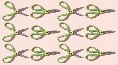 Pattern of open and closed kitchen scissors on a pale pink background. Stock Photos